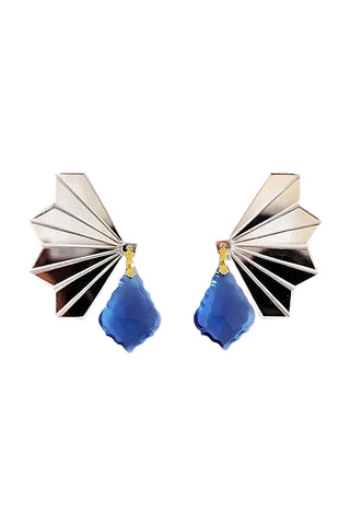 A pair of geometric drop earrings featuring a silver-toned fan-shaped stud with a faceted blue teardrop pendant, accented by small gold details, shown on a plain white background.