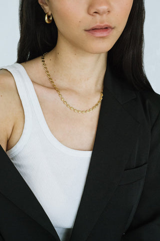 Model wearing gold Gemma necklace by Kara Yoo. 