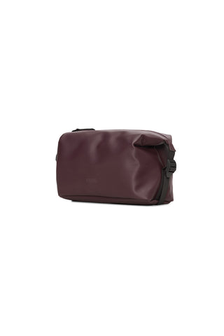 Burgundy toiletry bag with side buckles. 