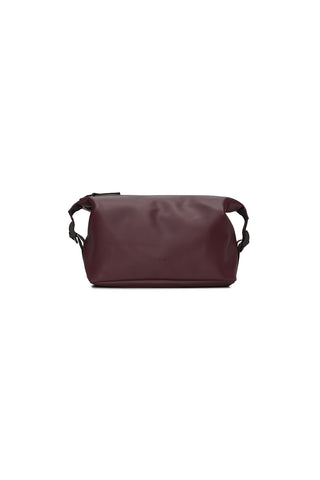 Burgundy toiletry bag with side buckles. 