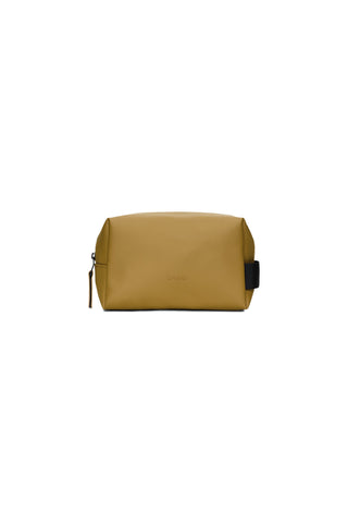 Mustard yellow small waterproof toiletry bag on white background. 