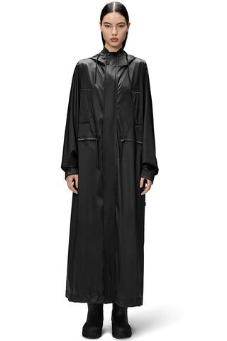 Model wearing black unisex waterproof and windproof full length Bold Longest Jacket by RAINS. 