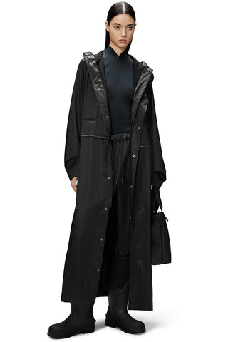 Model wearing unzipped black unisex waterproof and windproof full length Bold Longest Jacket by RAINS. 