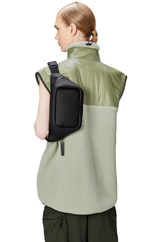 Model wearing black waterproof Bum Bag Mini W3 by Rains.