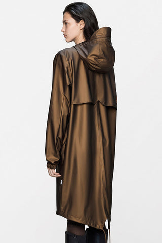 A back view of a woman wearing a metallic bronze-brown hooded raincoat against a plain white studio background.