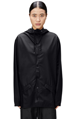 Woman wearing black waterproof unisex waterproof Jacket b Rains. 