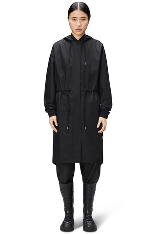 Woman wearing black waterproof fishtail String Parka by Rains. 