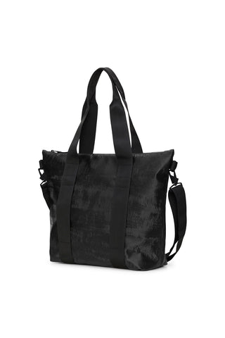 Side view of coal black RAINS Tote Bag Mini against white background. 