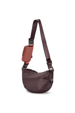 Side view of deep red Depth Rains Valera Shoulder Bag Mini in front of white background. 