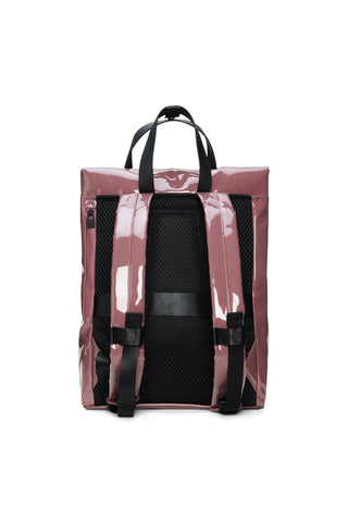 Back view of a glossy, dusty rose vinyl tote backpack with black handles and vertical straps, set against a plain white background.