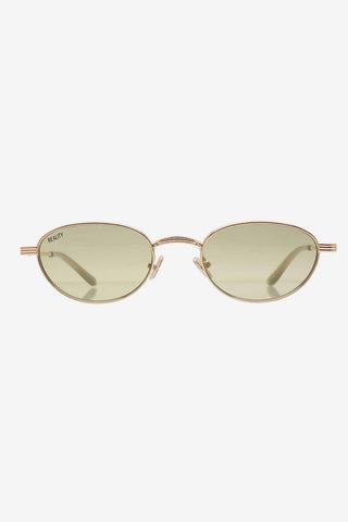 Gold metal sunglasses with light olive green lenses on white background. 