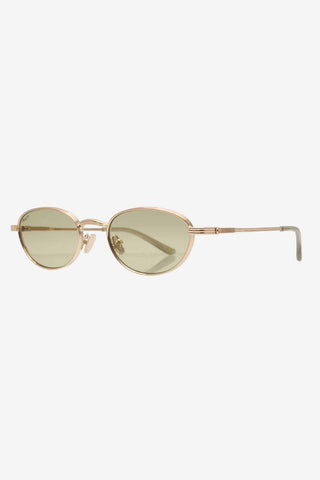 Gold metal sunglasses with light olive green lenses on white background. 