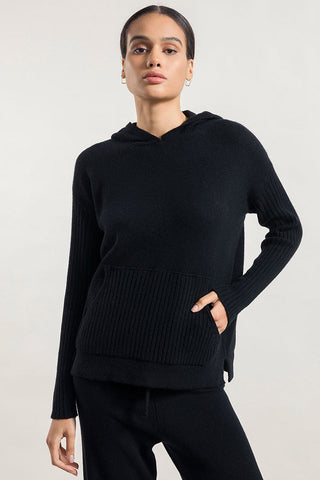 Model wearing black recycled cashmere Fiona sweater by Rifo. 