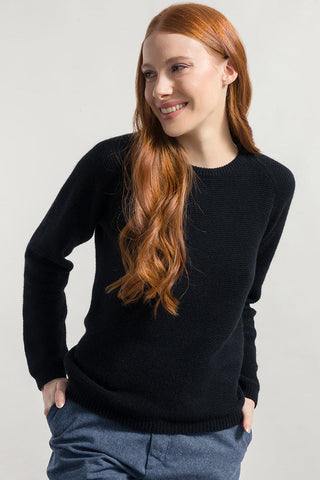 Model wearing black recycled cashmere crew neck Giulietta sweater by Rifo. 