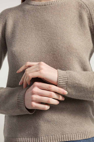 Closeup of beige recycled cashmere crew neck Giulietta sweater by Rifo. 