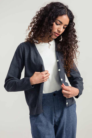Woman wearing grey organic / recycled cotton Lucia cardigan by Rifo. 