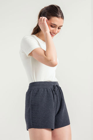 Woman wearing grey sporty recycled cotton / organic cotton blend Stella Shorts by Rifo. 