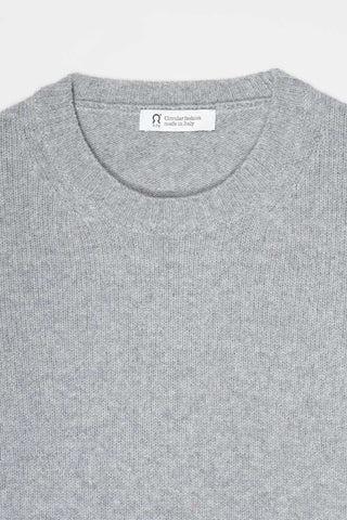 Close-up of a light gray knit crewneck sweater with a visible neck label reading 'Rifo: Circular fashion made in Italy'.