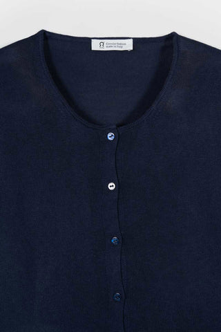 Close-up of navy blue cardigan by Rifo with Circular Fashion made in Italy tag. 