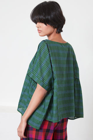 Model wearing green Zen Stripe Becca top by Rujuta Sheth. 