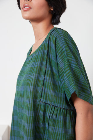 Closeup of model wearing green Zen Stripe Becca top by Rujuta Sheth. 