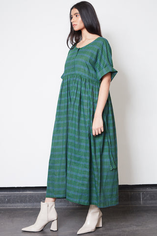 Model wearing green plaid hand loomed cottom Blythe Dress by Rujuta Sheth. 