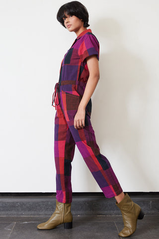 Side view of model wearing jewel tone large Kinetic Check Ray Jumpsuit by Rujuta Sheth. 