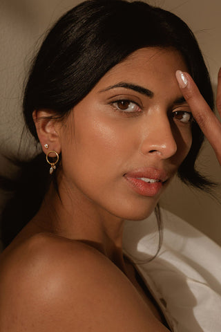 Model wearing gold Sarah Mulder Cali Earrings. 