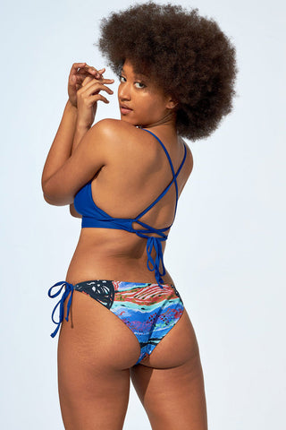 Back view of model wearing low rise recycled polyester Leah bikini bottom by Selfish Swimwear. 