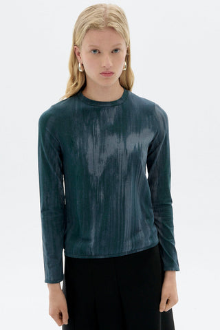 Woman in front of white background wearing blue organic cotton ombre print Brisa long sleeve top by Thinking Mu. 