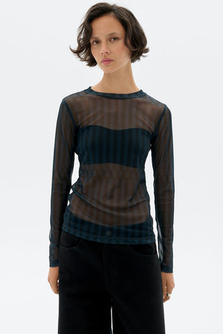 Model in front of white background wearing sheer blue stripe Esqué Tere top by Thinking Mu. 