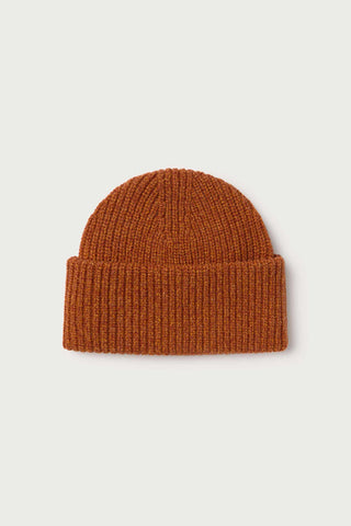 Flat lay image of orange thick rib knit Ruby Beanie by Thinking Mu.