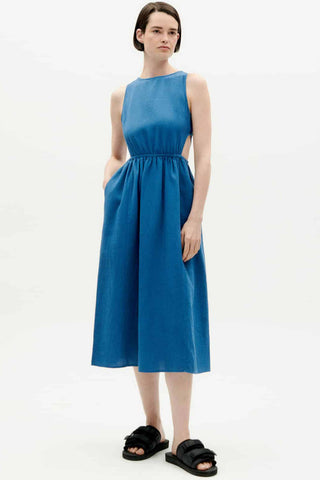 Woman wearing organic blue Kin dress by Thinking Mu. 