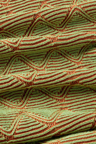 Close-up of green jacquard fabric. 