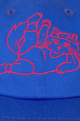 Close-up of a bright blue cap featuring a red embroidered cartoon exercising cat graphic across the front panels.