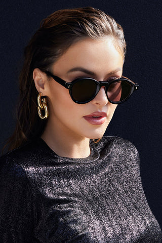 Woman wearing Valley Eyewear Motel Sunglasses in gloss black with black lenses. 
