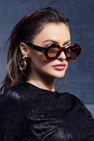 Woman wearing Valley Eyewear Opera Sunglasses in honey tortoise with light brown lenses. 