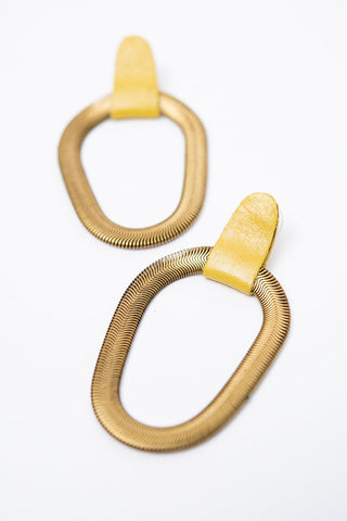 Yellow leather and brass 9e Avenue earring by Veinage. 