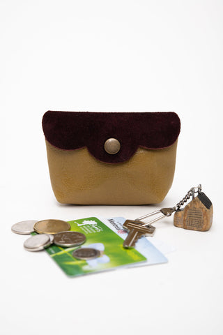 Burgundy with olive green leather coin pouch shown with coins, metro card & keys. 