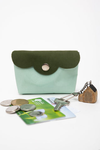 Green with light green leather coin pouch shown with coins, metro card & keys. 