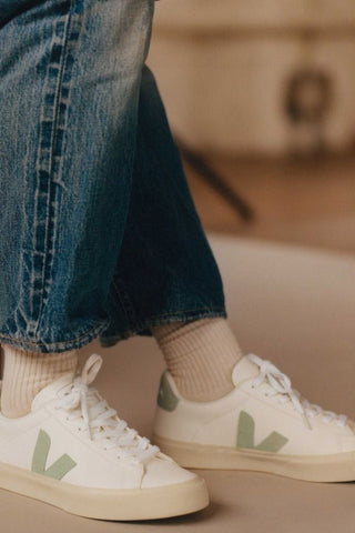Woman wearing Veja Chromefree Leather Campo White + Matcha green eco-friendly sneakers with tan socks and jeans. 