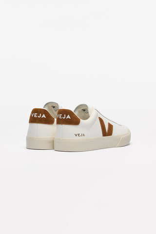 Back view of a pair of White + Cognac Veja Campo Leather shoes against a white background. Body of shoe is white leather, Veja V logo is cognac brown suede. 