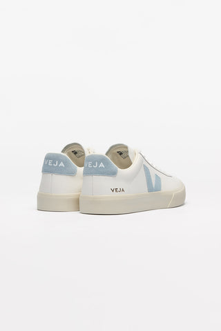 A back view of a pair of White + Steel Veja Campo Leather shoes against a white background. Body of shoe is white, Veja V logo is light blue. 