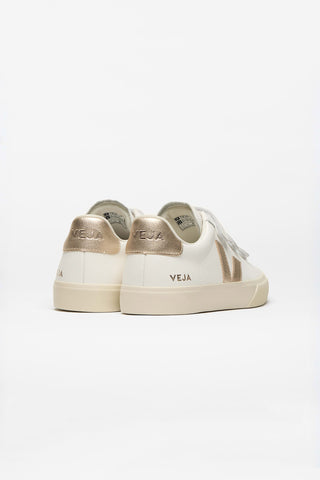 Back of pair of white Veja sneakers with light  gold detail. 