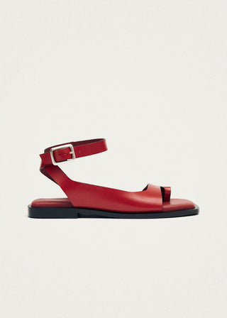 Red leather toe ring sandal with ankle strap. 