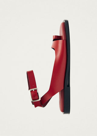Red leather toe ring sandal with ankle strap. 