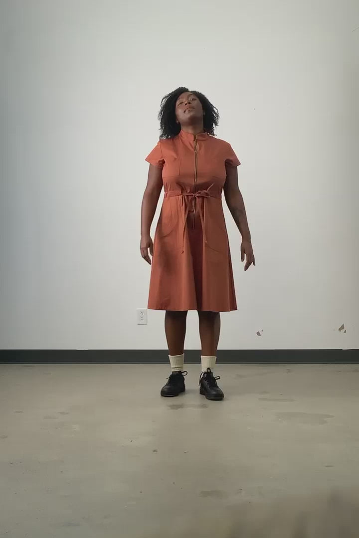 Video of model wearing rust organic cotton twill Jennifer Glasgow Cascade dress. 