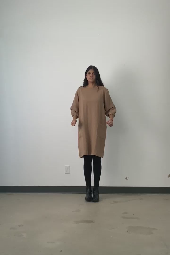 Video of model wearing Jennifer Glasgow Shui tunic dress in camel OEKO-TEK linen blend. 
