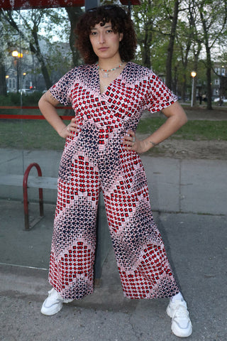 Model is wearing dice print wrap around Teshie Jumpsuit by Batik Boutik. 
