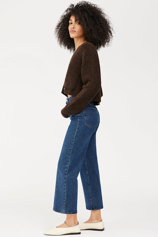 Side view of model wearing DL1961 Hepburn high rise wide leg jeans. 